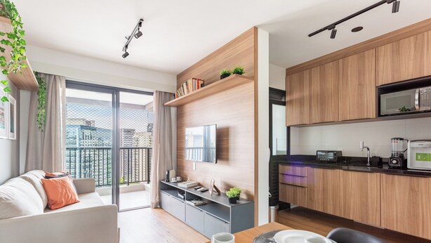 A modern apartment with a dining area, kitchen, and a balcony with a city view. - Expand Pinheiros  (São Paulo)