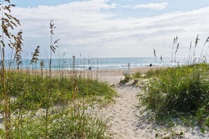 A sandy beach path leading to the ocean with sparse vegetation. - Southwinds H11 - 2 Bedrooms, 1.5 Baths, Oceanview Condo (Atlantic Beach)