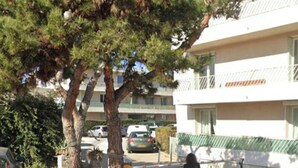 A residential building with a balcony, a tree in front, and parked cars. - T3 Sanary-Sur-Mer for rent Holiday 2026 (Sanary-sur-Mer)