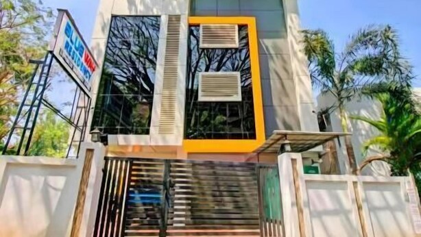 A modern building with a sign reading 'BLUE WAY ACADEMY.' - Blueway Residency BusinessBoutique Hotel (Thiruvananthapuram)