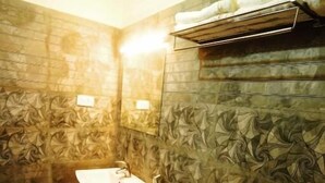 A bathroom with a toilet, sink, and towel rack. - Blueway Residency BusinessBoutique Hotel (Thiruvananthapuram)