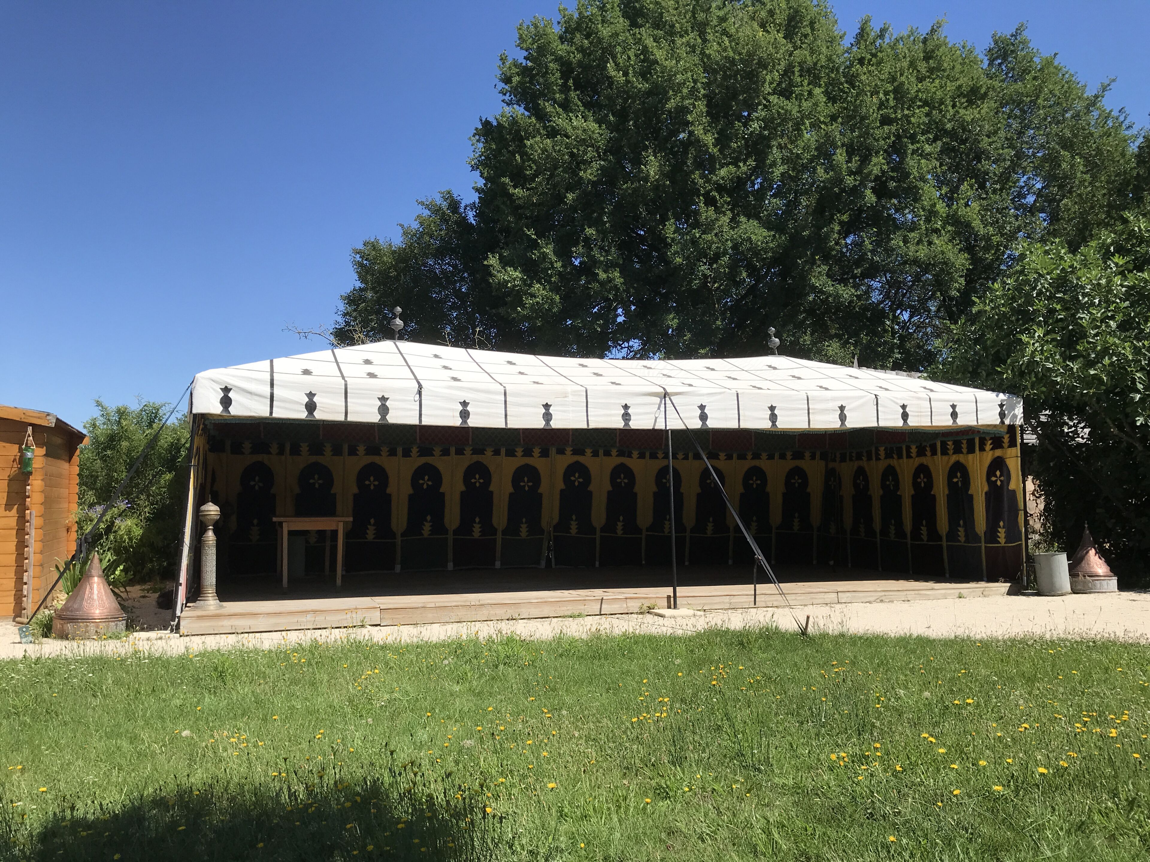 A covered outdoor area with a patterned roof and multiple arches.