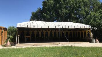 A covered outdoor area with a patterned roof and multiple arches.