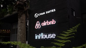 A building with signage for 'Cyan Suites,' 'Airbnb,' and 'Inhouse coworking & coffee.' - Cyan 1001 - 2BR in Medell n (Medellín)