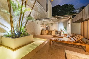 A spa area with a pool, wooden loungers, and potted plants. - Casa Provenza 34 6BR With Private Pool (Medellín)