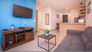 A modern living room with a flat-screen TV, wooden entertainment unit, and a grey sofa. - Oslo 609 in Medell n (Medellín)
