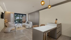 A modern living room with a dining area, large windows, and a kitchen. - Olive Country Living - 117 (Envigado)