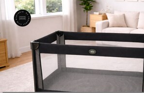 A baby playpen with a mesh top and a solid bottom, placed in a room with a white sofa and a wooden side table. - Oslo 2508-2 in Medell n (Medellín)