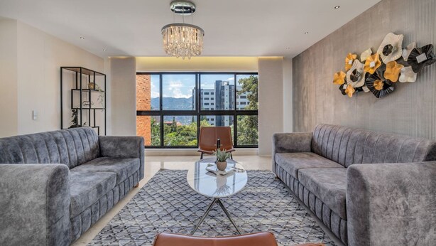 A modern living room with two sofas, a glass coffee table, and a chandelier. - 301 - Luxury 3BR Retreat Private Jacuzzi Nightclub AC (Medellín)