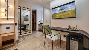 A modern hotel room with a fireplace, a large window with a scenic view, a mirror, and a small table with bottles. - LIN Hotel Suite Deluxe (Medellín)