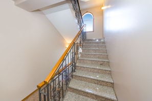 A staircase with granite steps, a wooden handrail, and metal railings. - Beachfront Apartment Mareo 3 (Nin)