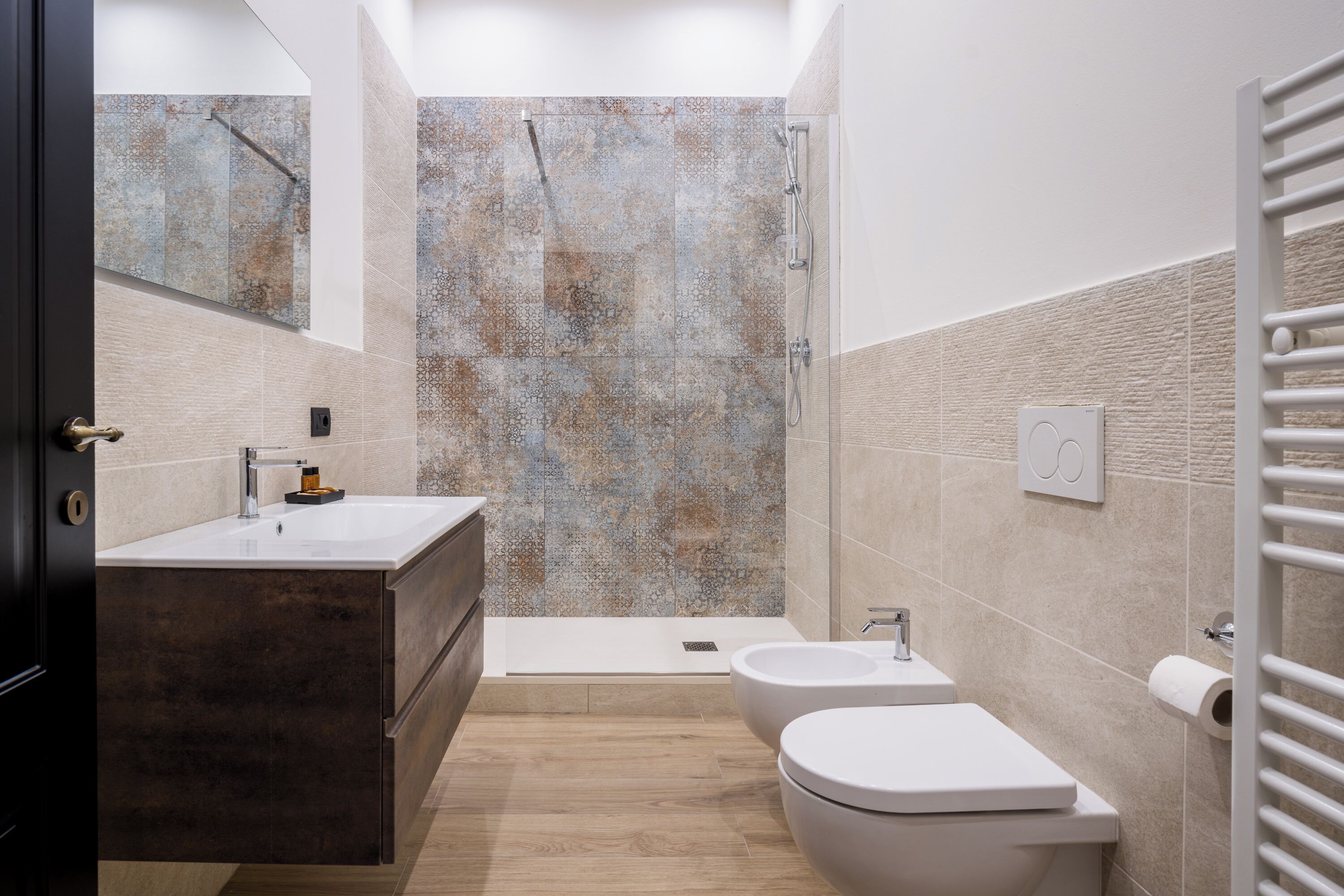 Un baño moderno con una bañera, dos lavamanos y un inodoro.