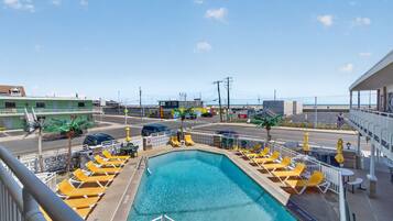 Seasonal outdoor pool, open 10:00 AM to 6:00 PM, pool umbrellas