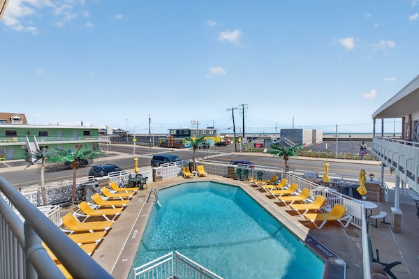 Seasonal outdoor pool, open 10:00 AM to 6:00 PM, pool umbrellas