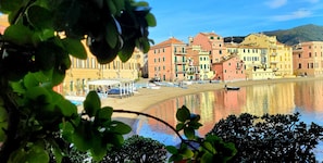 A coastal town with colorful buildings, a sandy beach, and a calm body of water. - Historic Center, 'Piazzetta della Torre' Apartment with Air Conditioning and Wi-Fi (Chiavari)