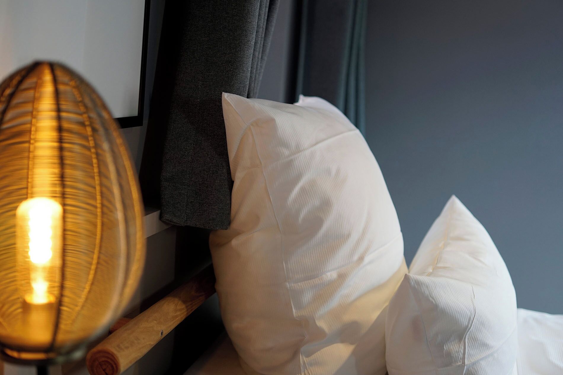 A lamp, a pillow, and a piece of clothing on a surface.