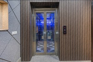 An elevator with a digital display showing 'ASSISTANCE' and a floor indicator. - Mauryan Elite Hotel Ignou Road (New Delhi)