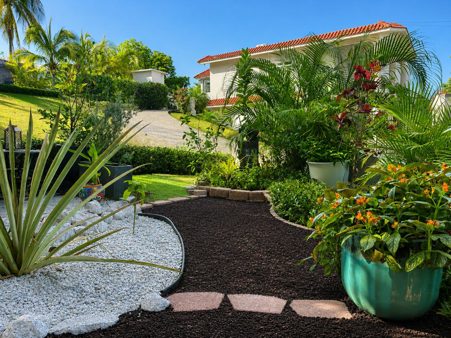 A landscaped garden with a pathway leading to a house with a red-tiled roof.