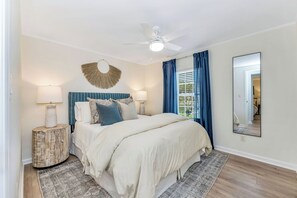 A bedroom with a bed, bedside lamps, a ceiling fan, a round mirror, and a window with curtains. - Lakefront Retreat w/ Boat Dock, Hot Tub & Large Game Room!  Sleeps 10 (Denver)