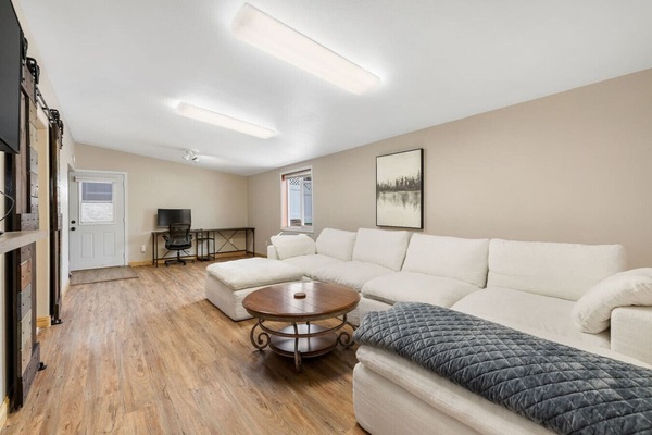 Relax in a bright, airy living room designed for both comfort and functionality.