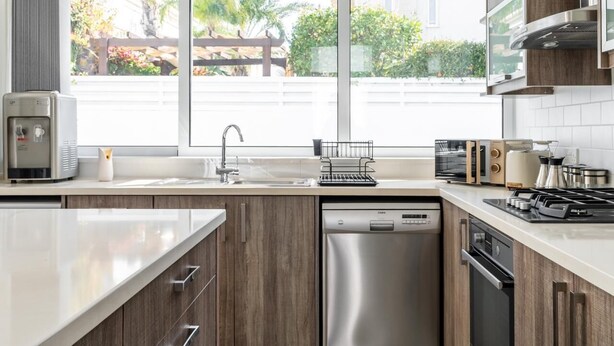 Una cucina moderna dotata di lavastoviglie, macchina per il caffè e tostapane.