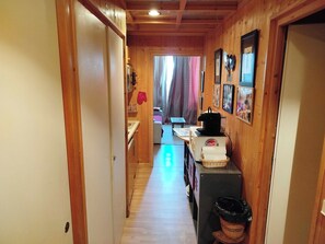 A wooden interior hallway with a kitchen area, including a coffee machine and a basket. - Studio with balcony and parking in Megève (Megève)