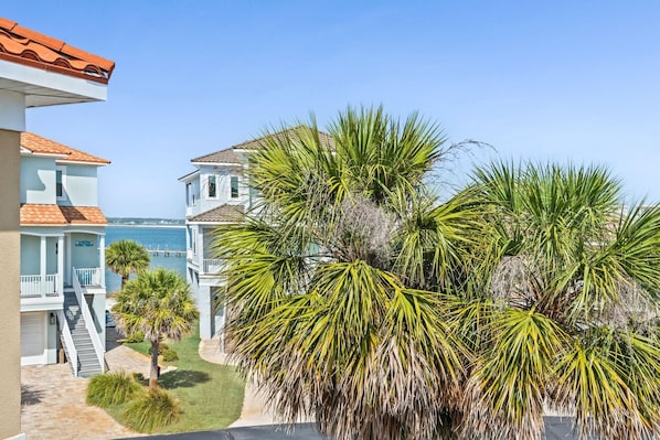 A coastal property with a clear view of the sea, a white building with a red roof, and lush greenery. - The Salty Pelican (Navarre)