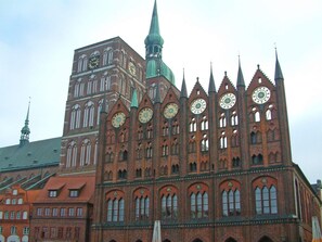 A large brick building with multiple spires and clock faces. - 4 Star Holiday Home in Sagad (Sagard)