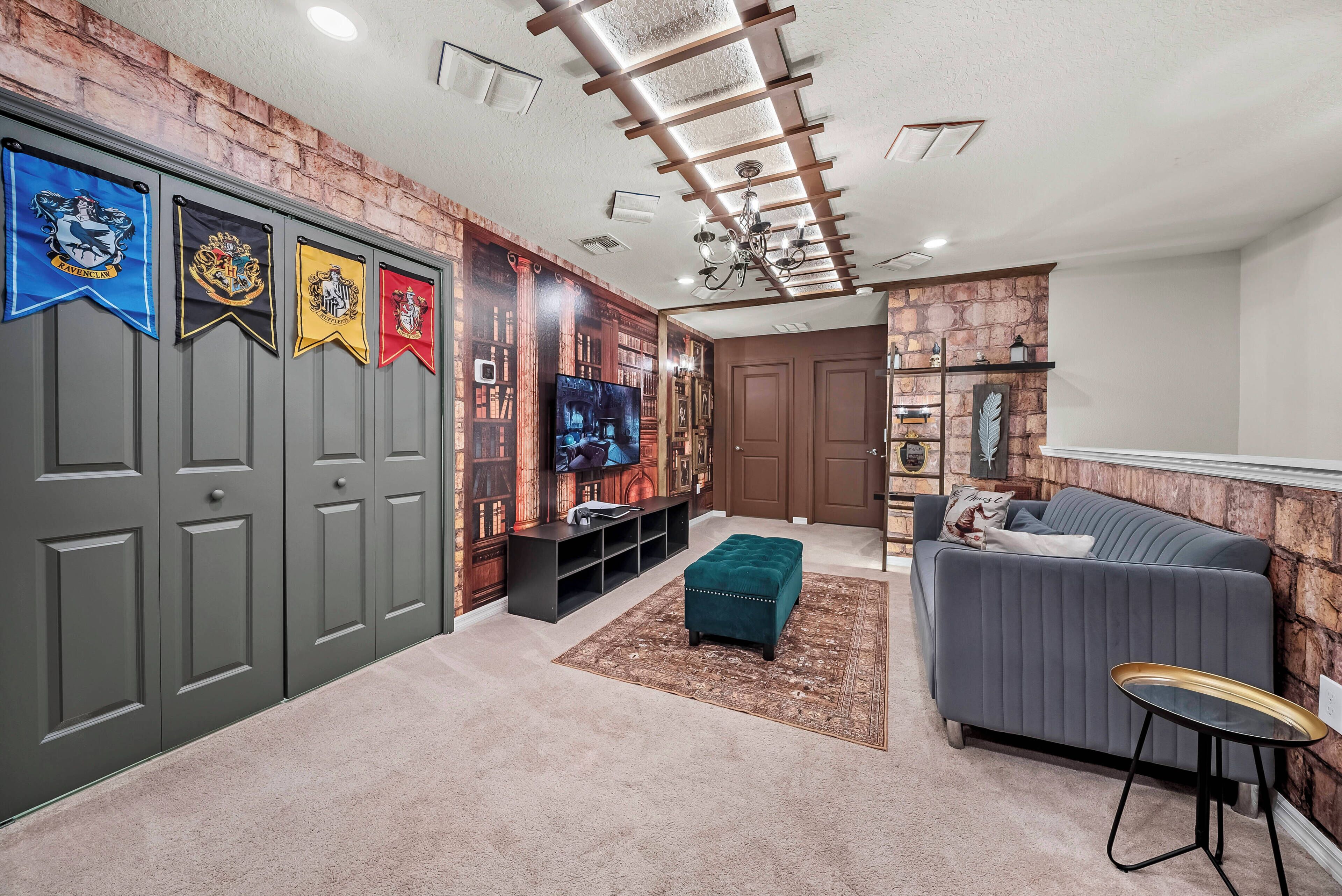 Enter a uniquely themed space that combines comfort with playful decor, featuring cozy carpets and vibrant banners. Relax on the plush gray sofa while the stylish green ottoman adds a fun touch to this inviting gathering area.