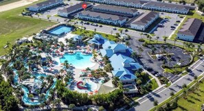 Discover a vibrant outdoor paradise with a stunning pool area, winding water slides, and lush landscaping. The bright blue roofs invite you to relax and enjoy the colorful atmosphere, making it the perfect spot for your getaway. - 5BR townhouse with private pool in davenport (Davenport)