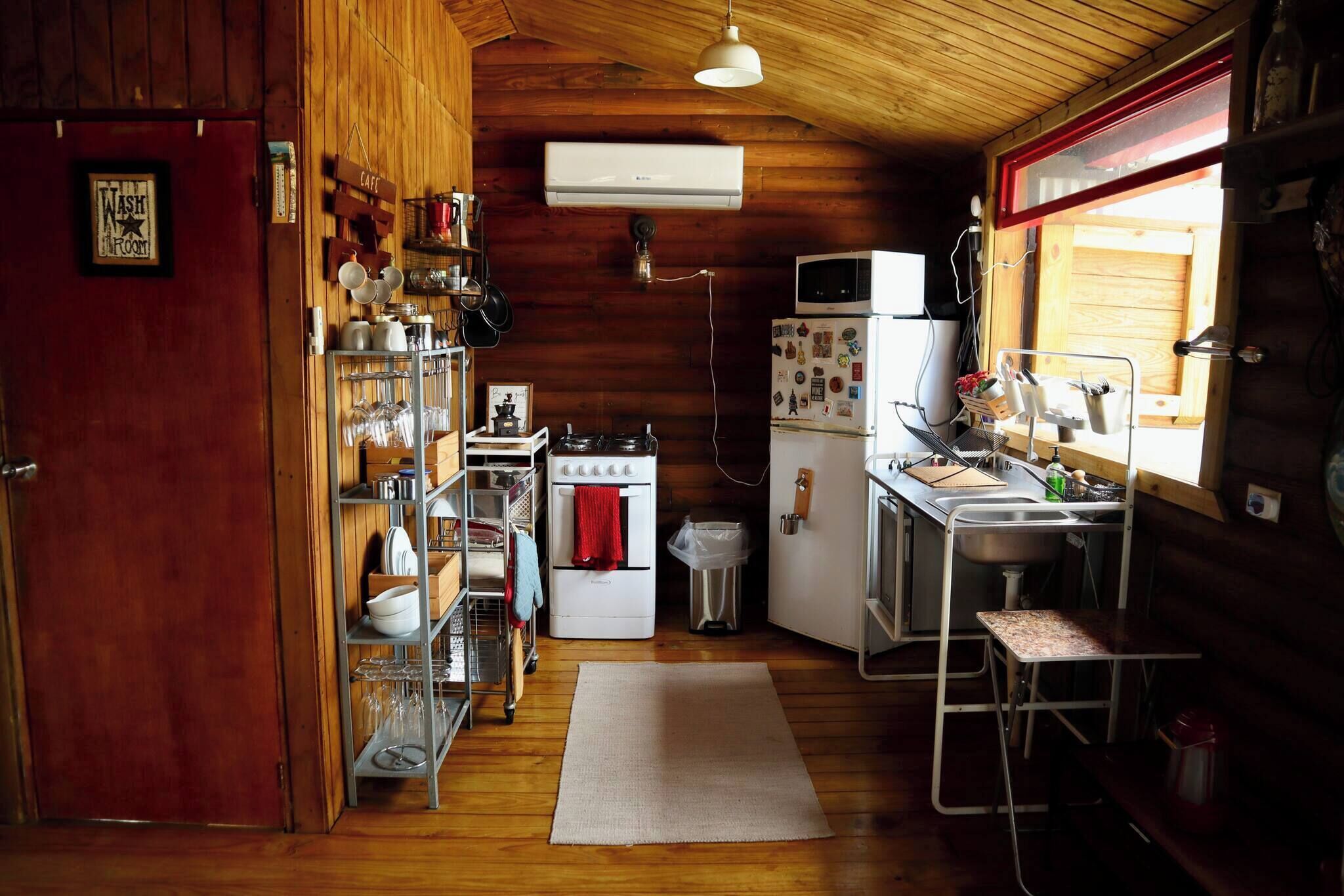 Fridge, microwave, coffee/tea maker, cookware/dishes/utensils