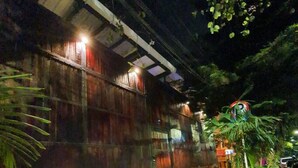 A building with a wooden exterior and a paved entrance area. - Casa Madera Parque Lleras With Private Jacuzzi (Medellín)