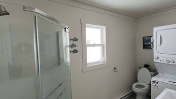 Shower, hair dryer, towels, shampoo