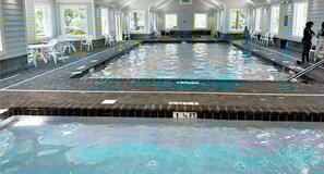 An indoor swimming pool with clear water, a tiled deck, and chairs along the sides. - 3bd/2bth home in Keys @ OceansideVillage-3 min walk to the beach! Golfcart avail (Surfside Beach)