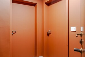A room with two closed doors, a visible light switch, and a metallic handle on the right door. - A welcoming and functional studio, conveniently located in a area with excellent metro access, perfect for reaching the city center in just a few minutes and easily traveling to San Salvario. The location is also ideal for those needing to reach the Po R (Turin)