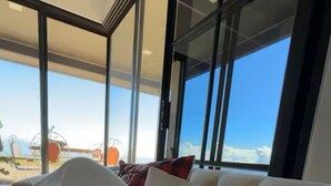 A modern bedroom with a large window, a bed with white bedding, and a view of the sky. - House Airy Luxury+WiFi+Amazing View At Alajuela CR (Provincia de Alajuela)