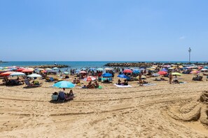 A sandy beach with numerous colorful umbrellas and beach chairs. - Bohemian Nights by Fidalsa (Torrevieja)