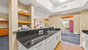 A modern kitchen with white cabinets, granite countertops, and a built-in oven. - Family-Friendly Townhome at Sand Castle Village- Pool, Lake & Fun! (New Bern)