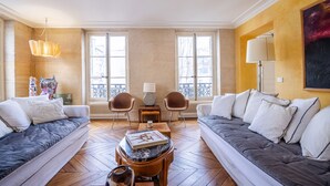 A living room with two sofas, a coffee table, and a lamp.