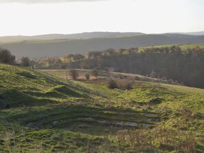 A rural landscape with rolling hills, a stone wall, and a few scattered trees. - 2 bedroom accommodation in Darwin Lake, near Matlock (Darwin Lake, near Matlock)