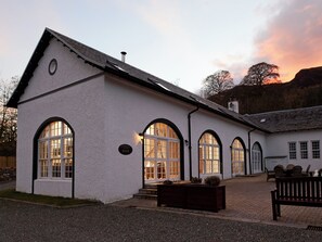 A white building with arched windows and a sign indicating it's a lodge. - Glendaruel Lodge - SXXN (Glendaruel)