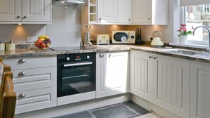 A kitchen with white cabinets, a built-in oven, a microwave, and a toaster. - 3 bedroom accommodation in Ambleside (Ambleside)