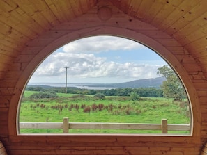 A wooden arched window with a view of a green field and distant hills. - Drumwall - Annabelle's Den (Gatehouse of Fleet)