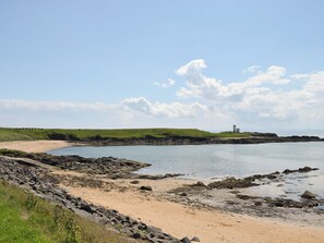 A coastal landscape with a lighthouse, rocky shoreline, and grassy areas. - 2 bedroom accommodation in Upper Largo, near Leven (Upper Largo, near Leven)