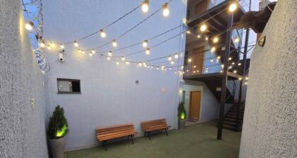 Fully equipped apartment with air conditioning, linens, laundry facilities, and a grocery store.