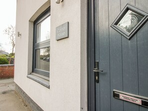 A building with a sign reading 'Corner House' and a door with a 'WARNING PRIVATE PARKING ONLY' sign. - Corner House (Shrewsbury)