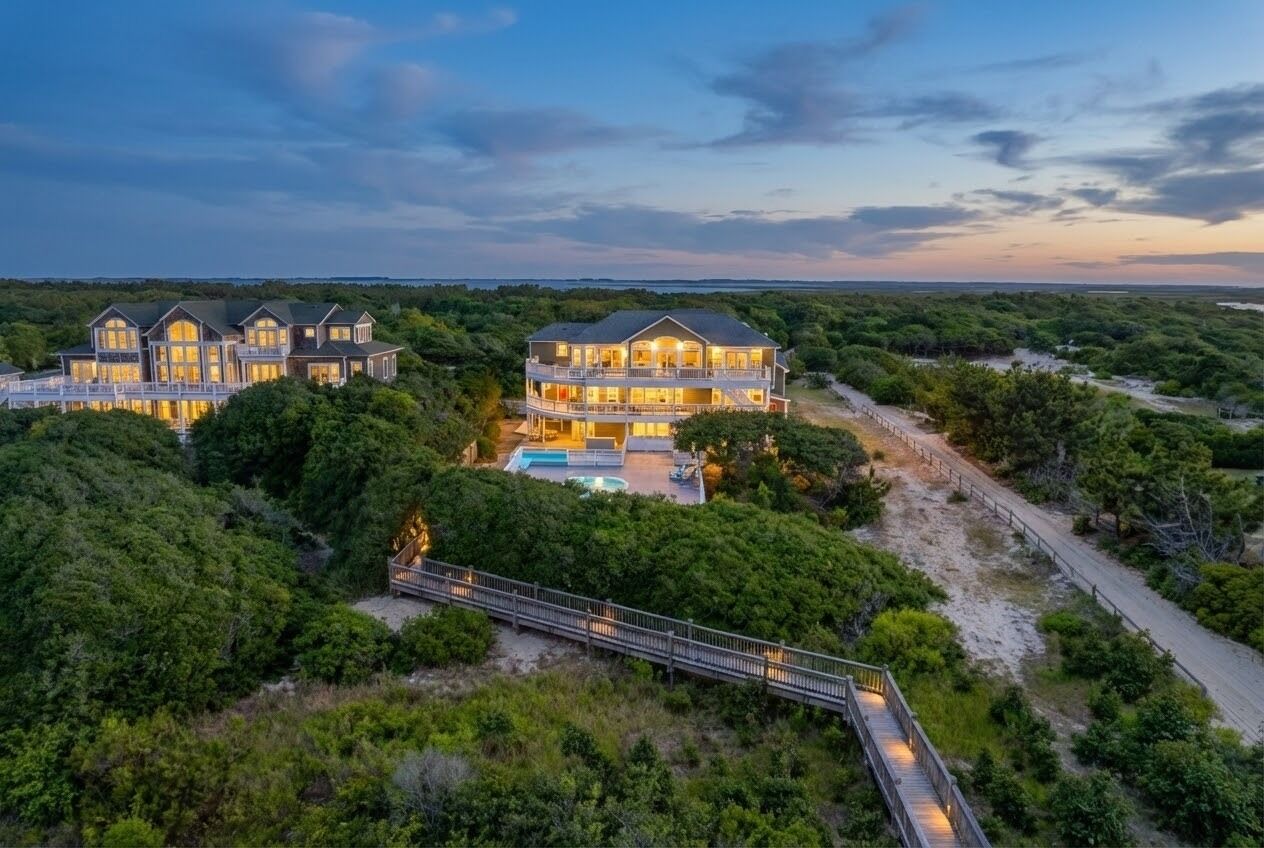 Commanding oceanfront presence — The Fitzgerald Estate at golden hour, showcasing three levels of luxury living with panoramic Atlantic views and lush coastal landscaping