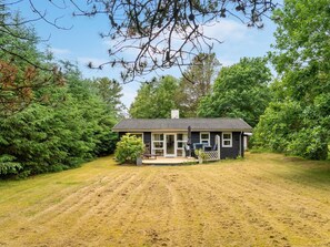 A single-story house with a front porch, a small deck, and a covered outdoor seating area. - "Jamie" -  from the sea by Interhome (Hals)