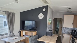 A compact kitchenette with a microwave, toaster, and coffee maker. - 158 South Happy Days - Sleeps 8 (Skegness)