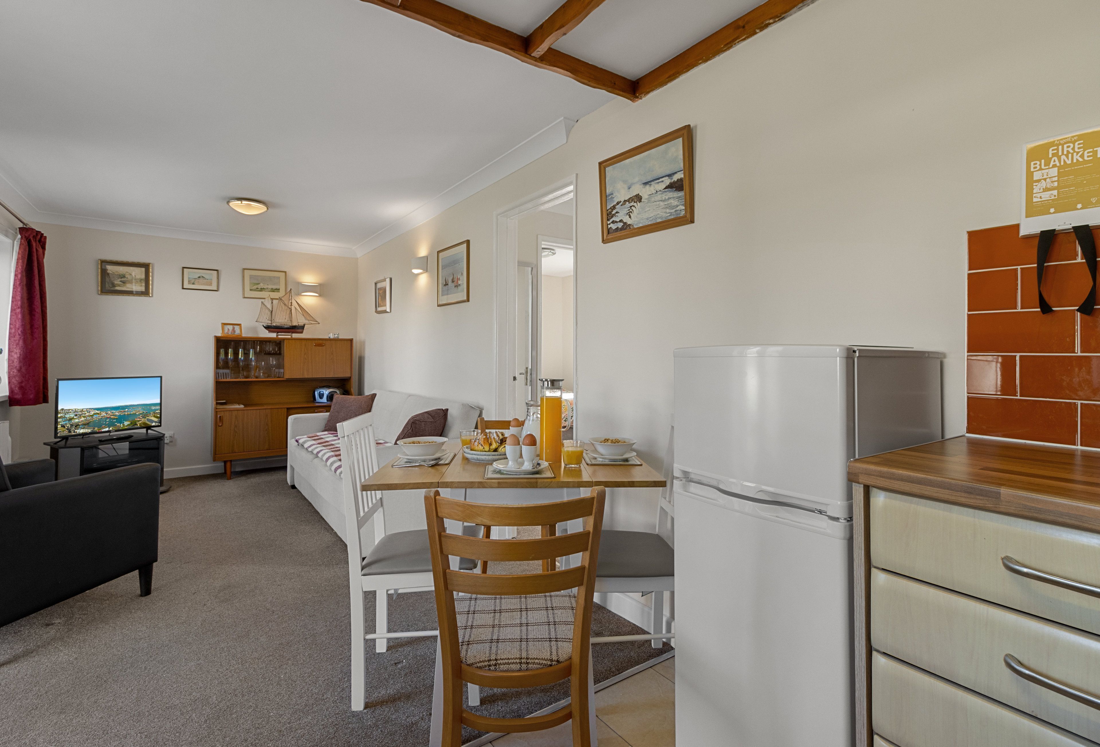 A compact living space with a dining area, kitchen, and seating area.